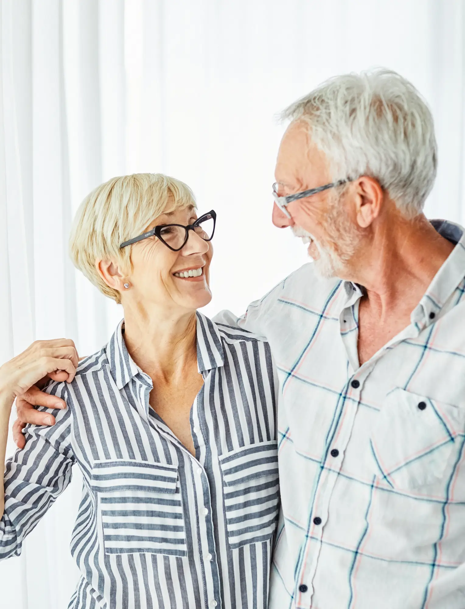 A well-rested older couple smiling together